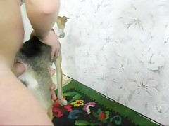 Jovencita dandole de comer almeja a su perro